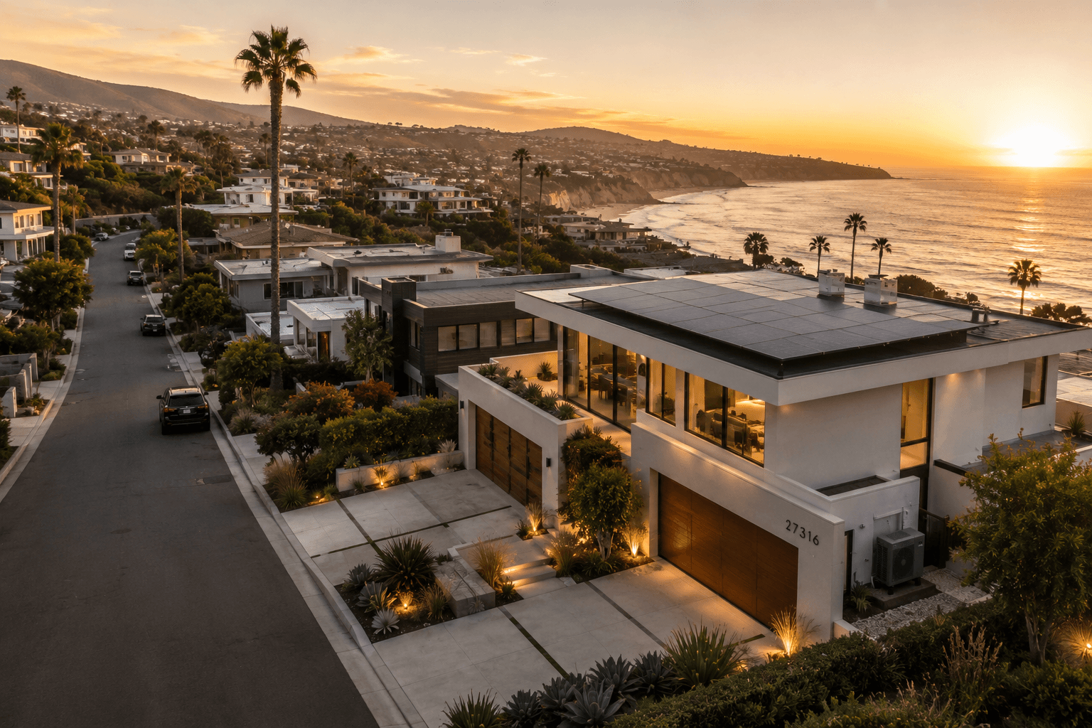 A coastal neighborhood of modern homes at golden hour